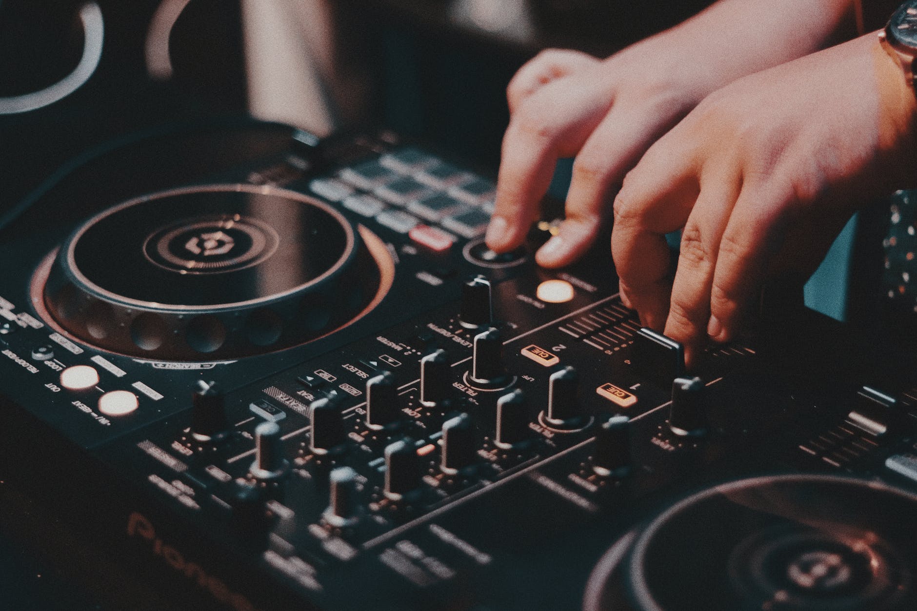close up of a dj using a console